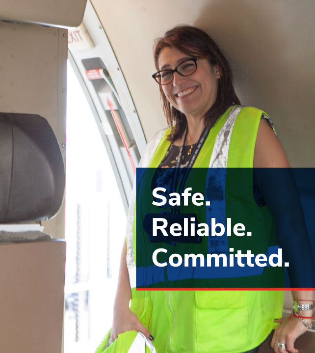 Photo of StratAir employee with a logo that says: Safe, Reliable and Committed. 